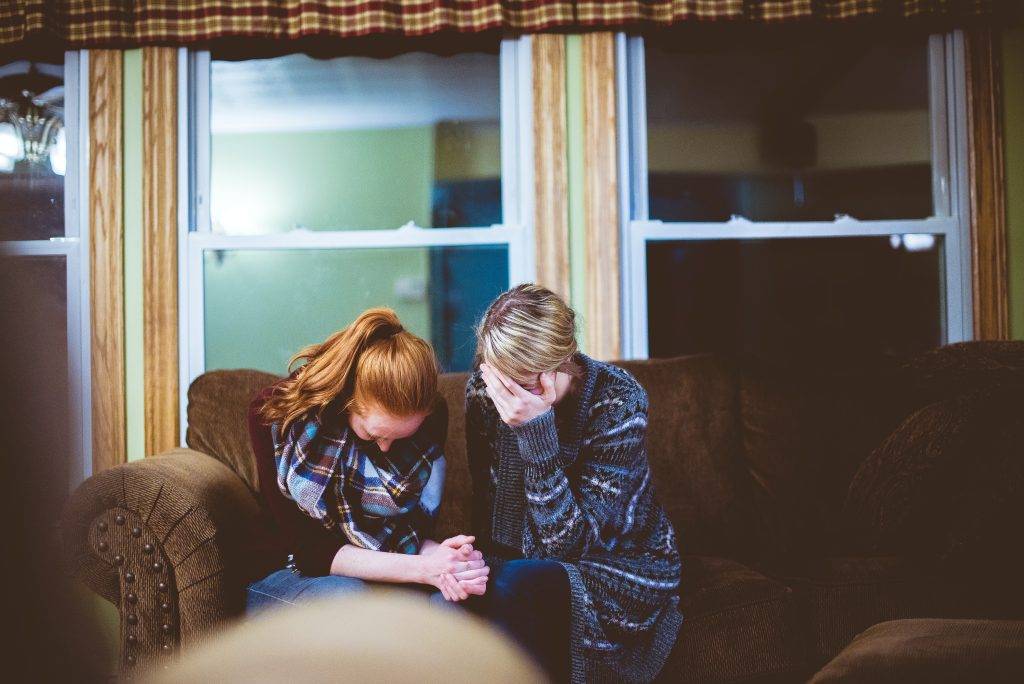 daughter-mother-grieving-sitting