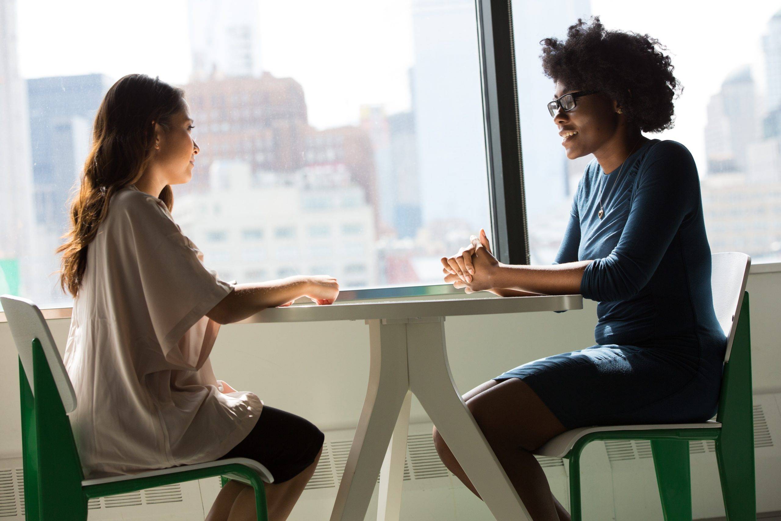 two-women-talking-at-table