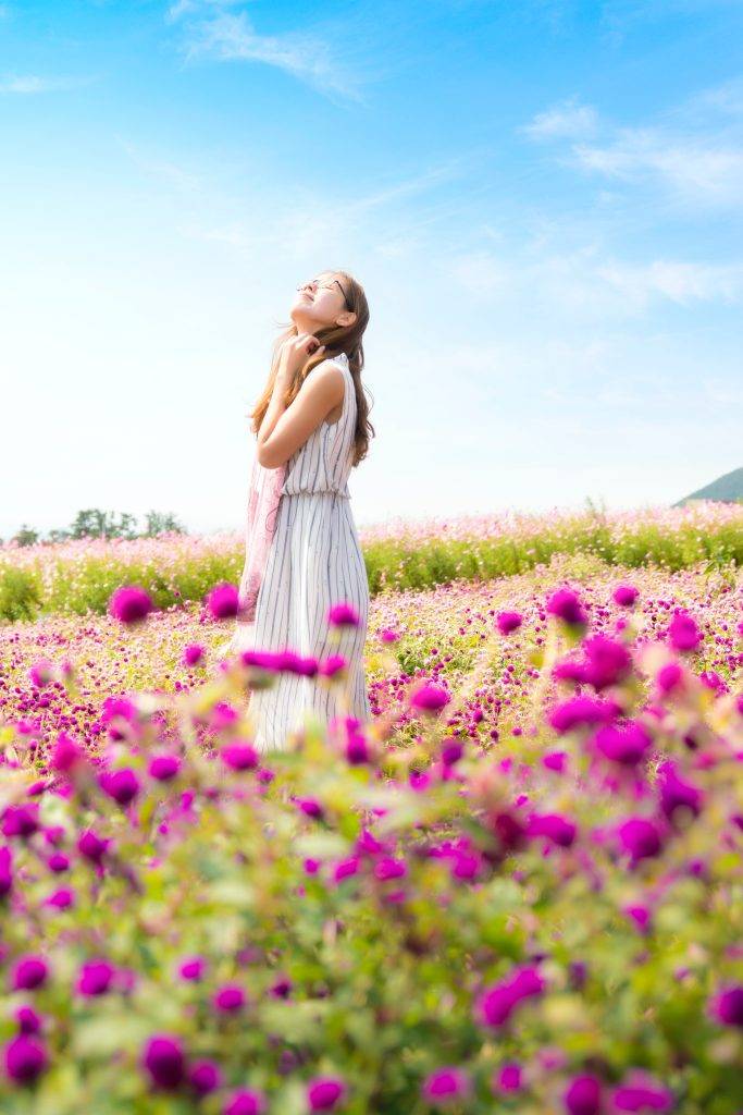 tuesday-afternoon-woman-standing-in-field-pink-flowers-white-dress