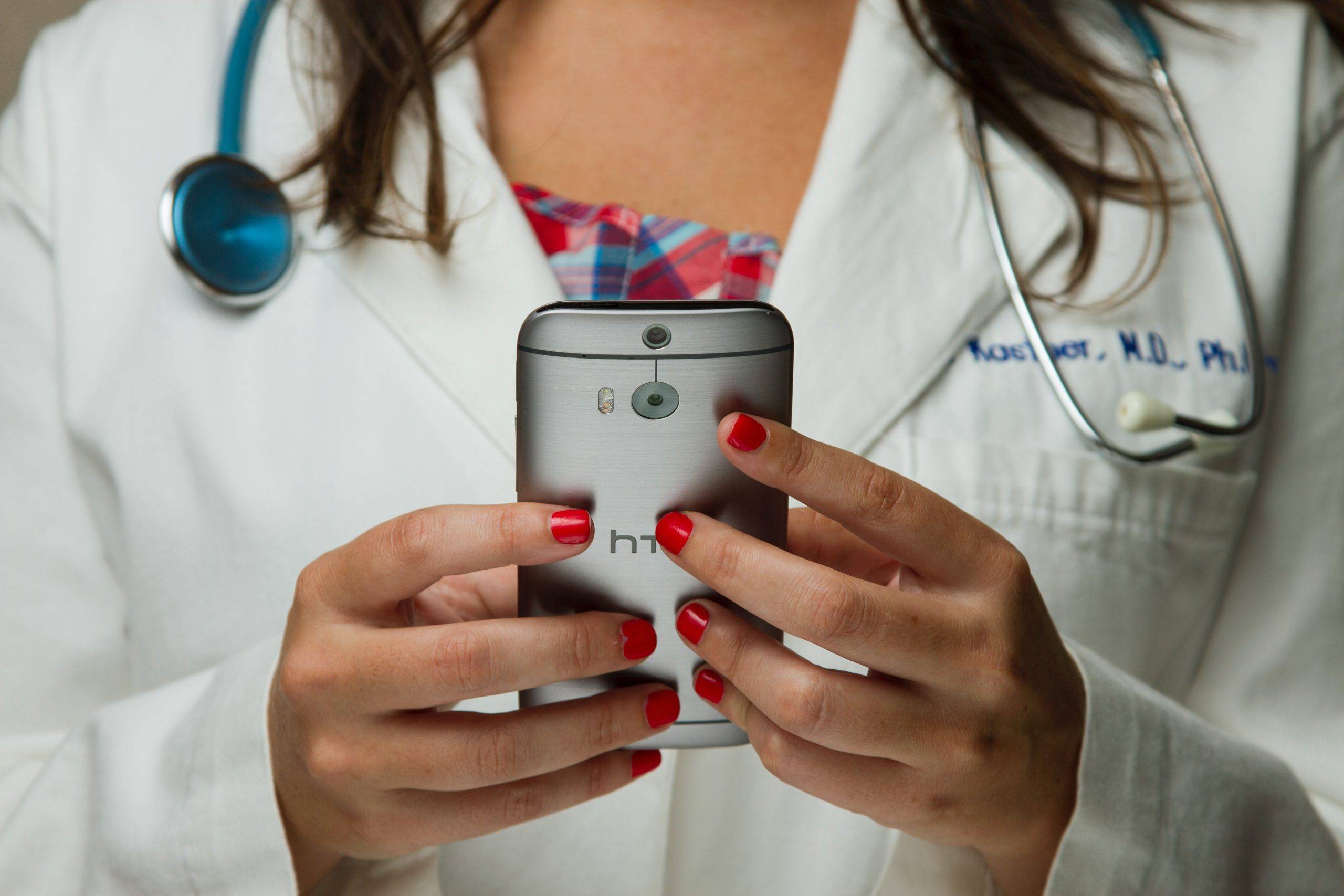 woman-doctor-white-lab-coat-holding-phone-determine-surgical-abortion