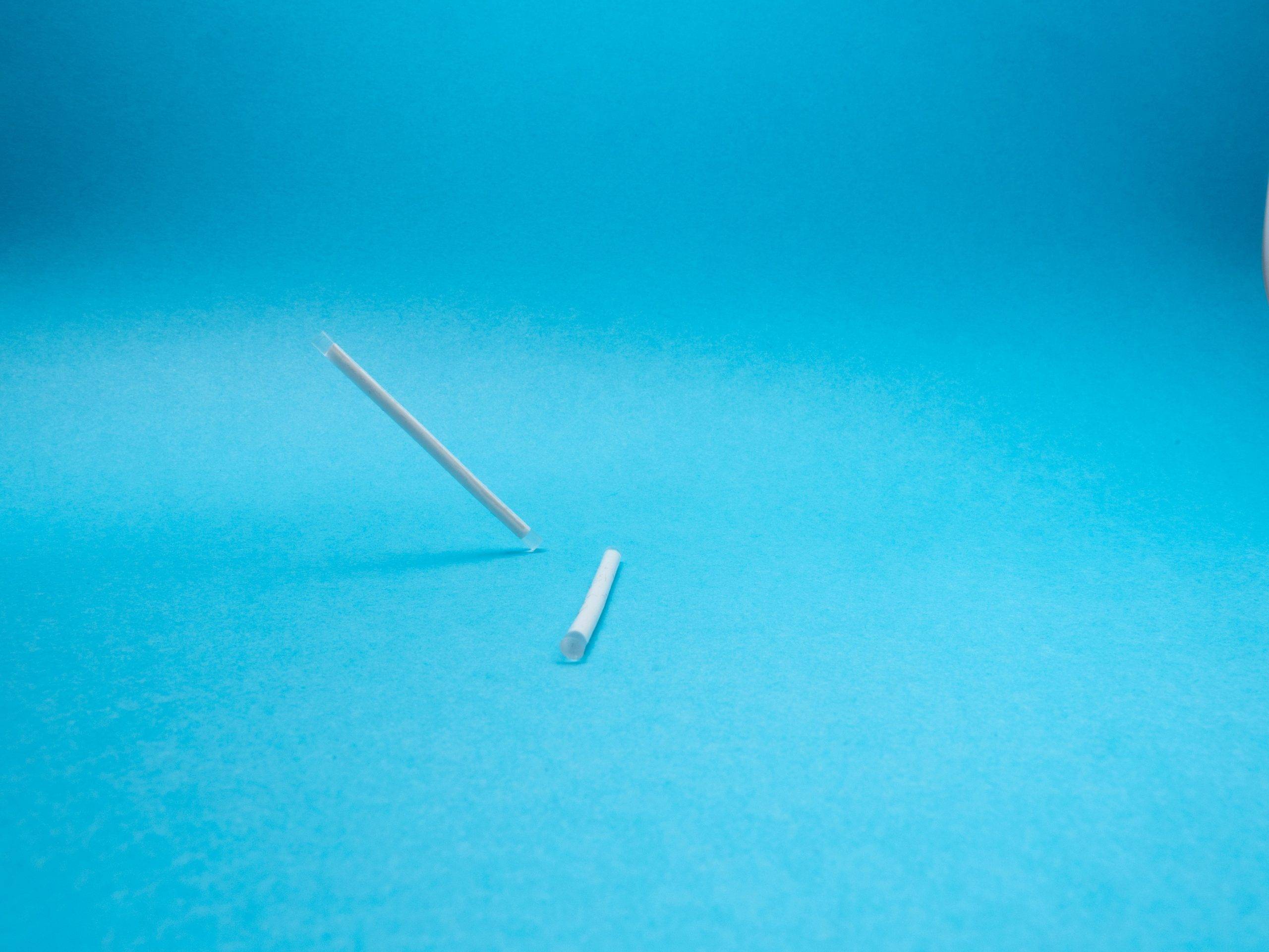 blue-background-two-white-plastic-wires