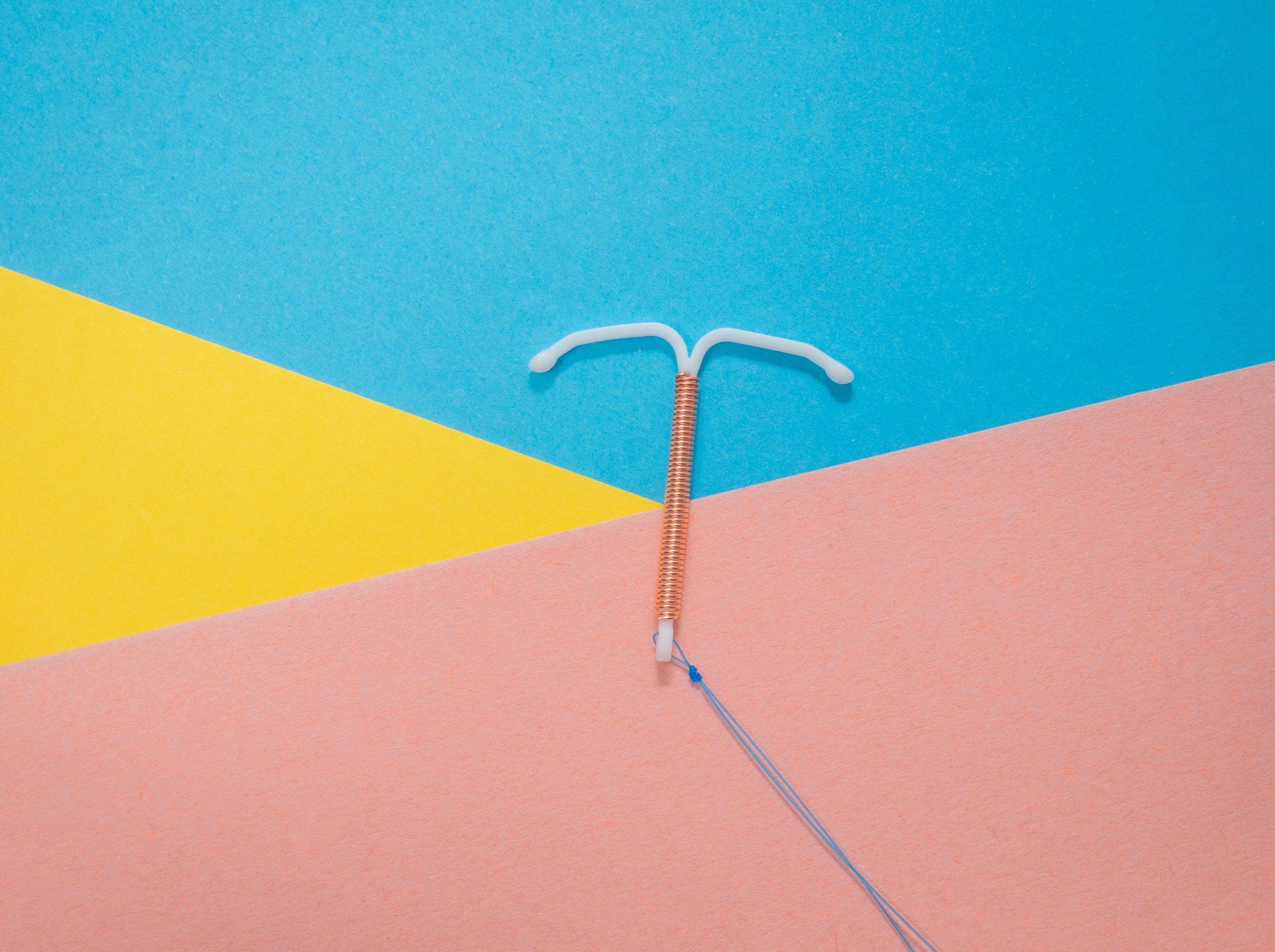 pastel-pink-blue-yellow-background-copper-iud