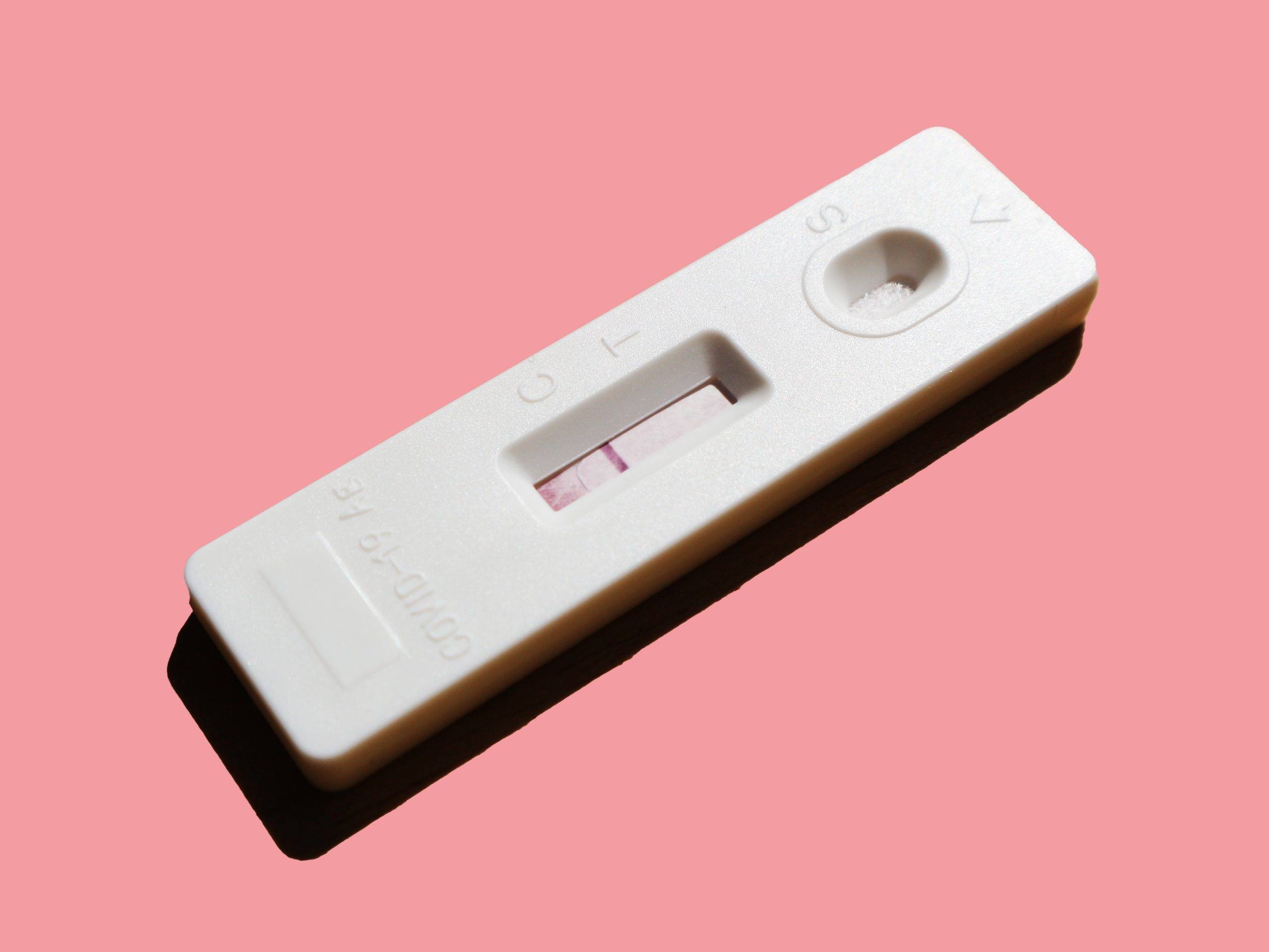 pink-background-pregnancy-test